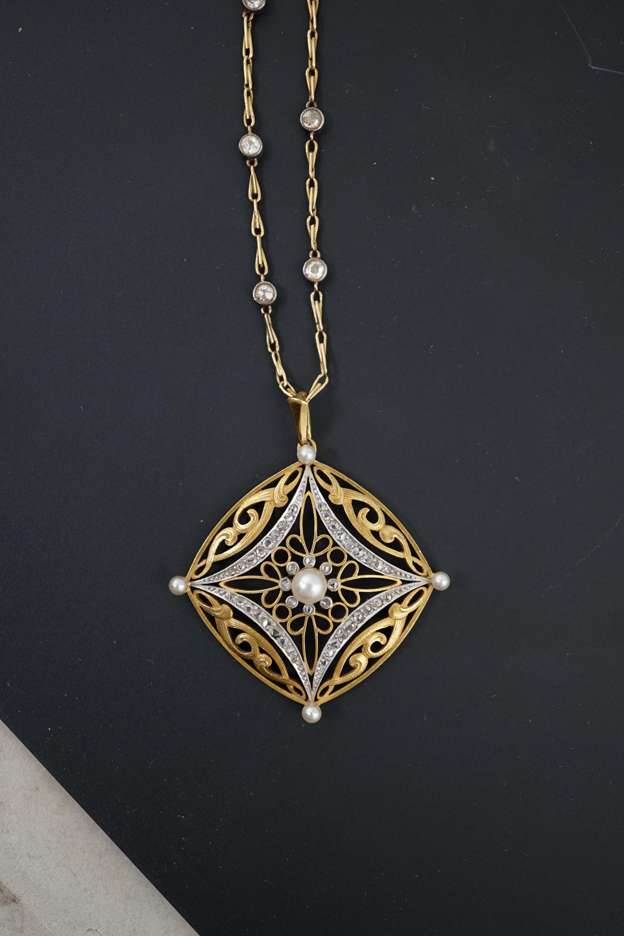 A French Belle Epoque pierced 18k gold, seed pearl and rose cut diamond set pendant, on a French 18k gold and diamond set spectacle necklace